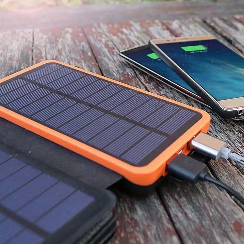 Compact folding waterproof solar power bank. High-capacity portable charger for adventurers.