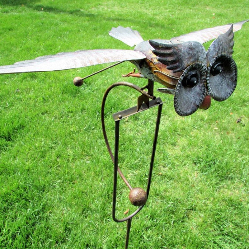 Unique wind-powered owl kinetic bird statue. Metal garden art decor, weather-resistant outdoor patio decoration.