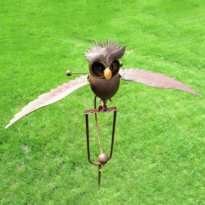 Weather-resistant kinetic bird garden art statue. Wind-powered outdoor metal decor, creating movement for your patio.