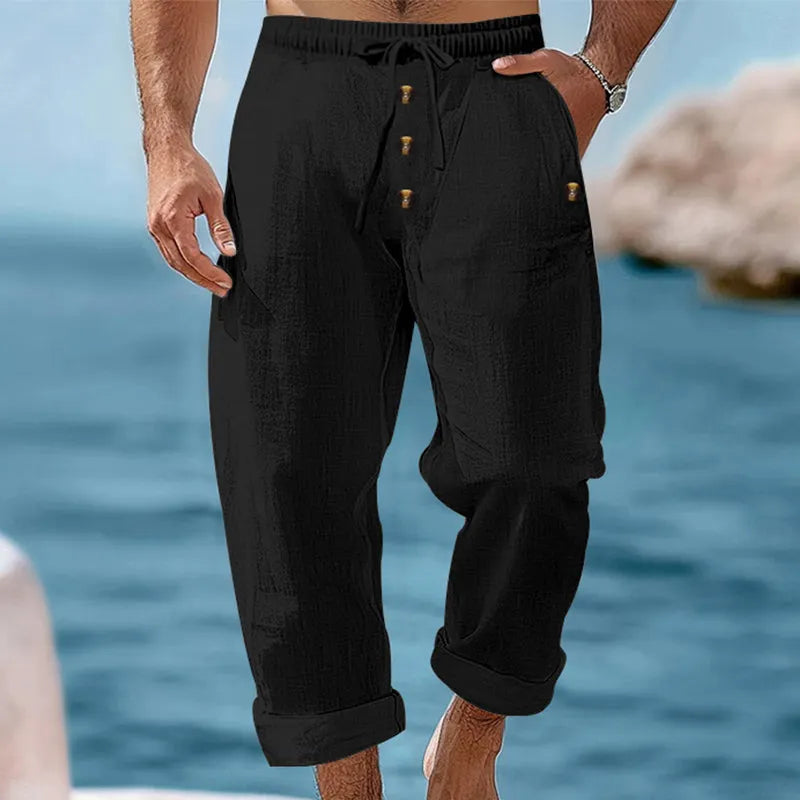 Men's relaxed fit linen cargo pants in a neutral color, styled for a casual summer day look.