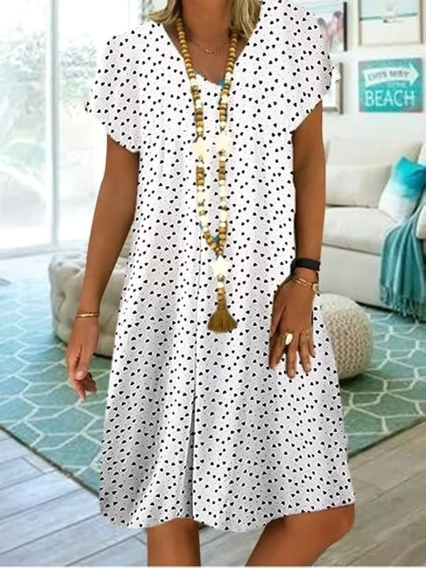 Elegant women's polka dot midi dress with flowy fabric, ideal for chic casual summer fashion.