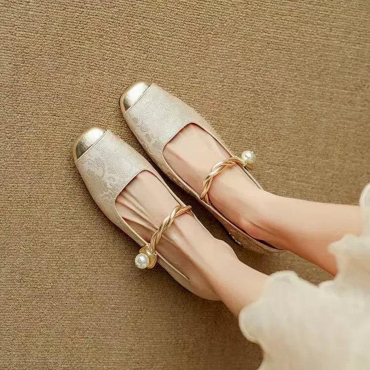Side view of women's vintage pearl strap Mary Jane shoes, elegant block heel visible.