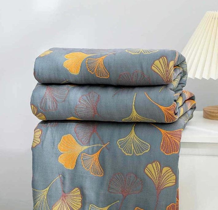 Reversible ginkgo leaf throw blanket in cozy yellow & blue, perfect for living room home decor.