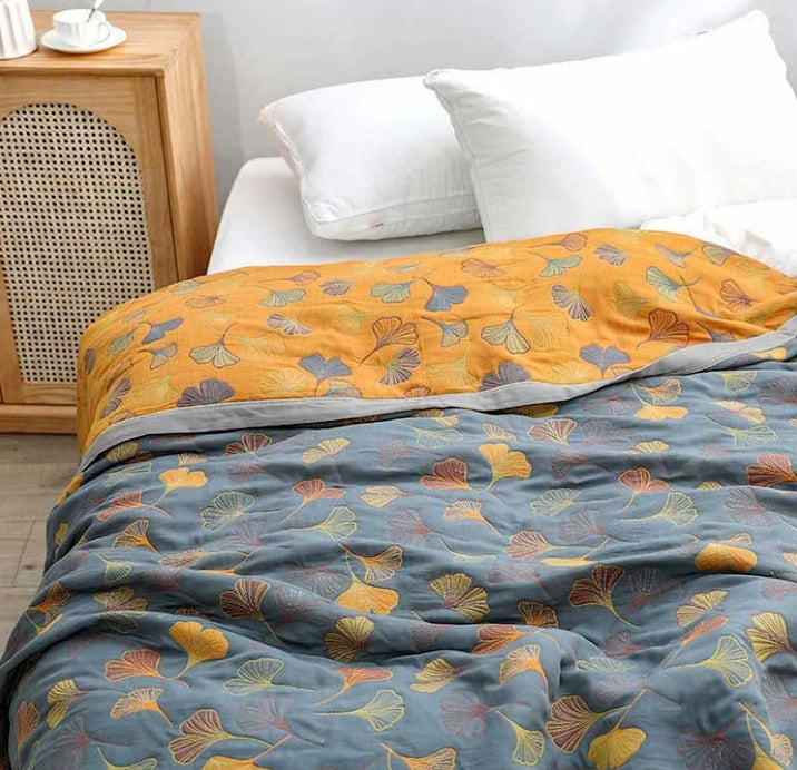 Cozy reversible ginkgo leaf throw blanket, blue & yellow, ideal for stylish living room home decor.
