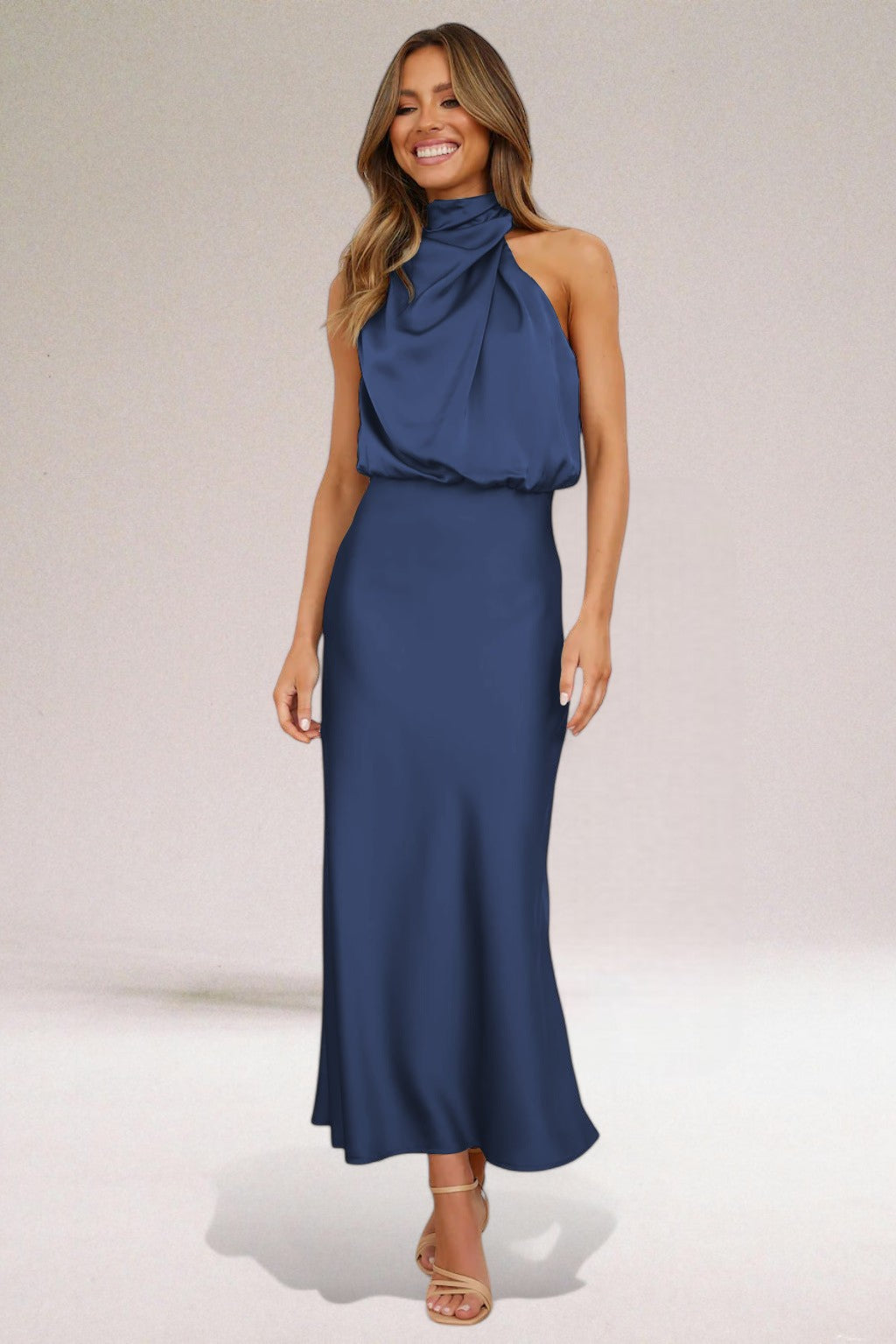 Woman in a stunning glamorous halter neck maxi dress, perfect for evening galas & special occasions.