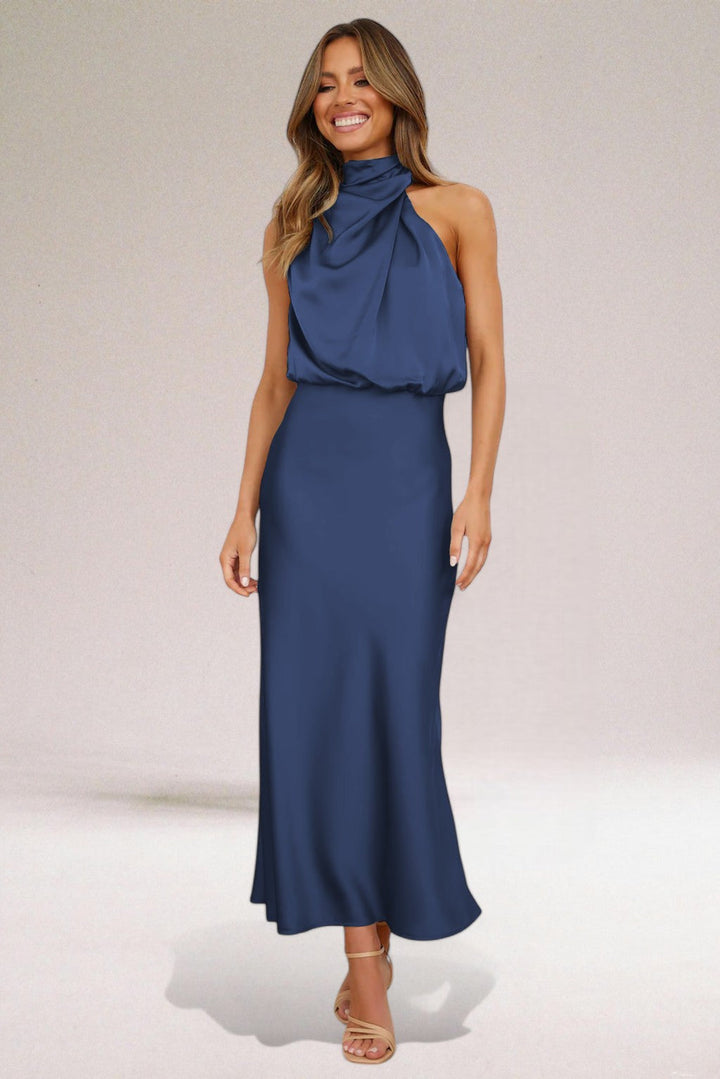 Woman in a stunning glamorous halter neck maxi dress, perfect for evening galas & special occasions.