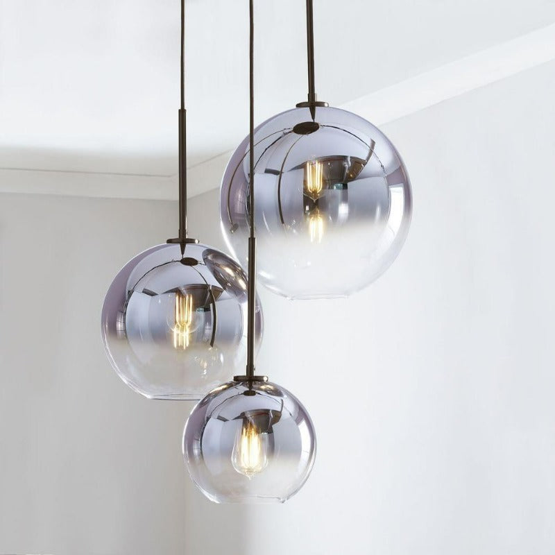 Sleek silver gradient glass pendant light, a contemporary indoor lighting for dining room decor.