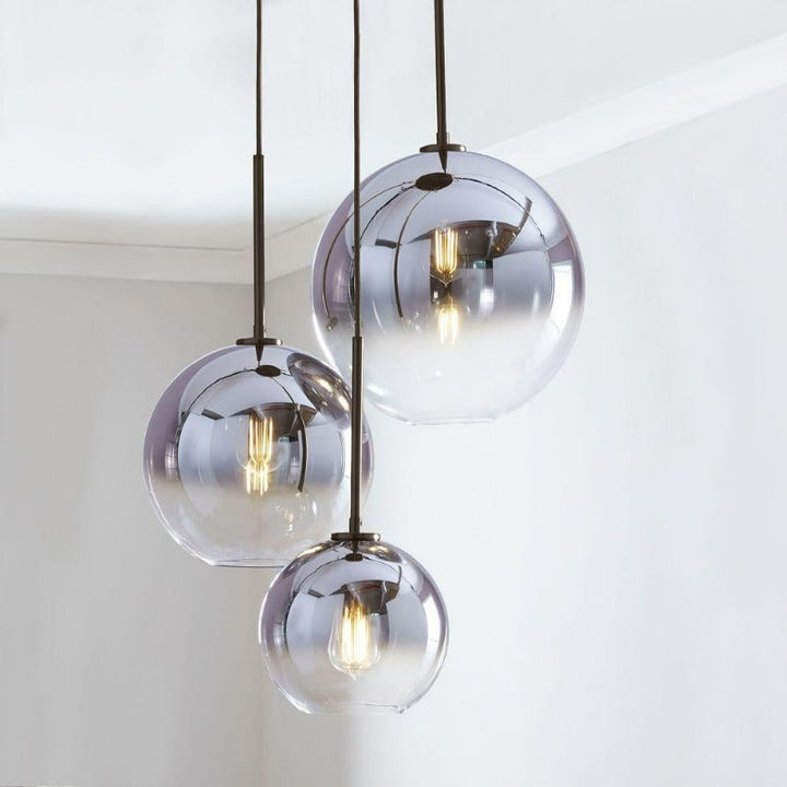 Sleek silver gradient glass pendant light, a contemporary indoor lighting for dining room decor.