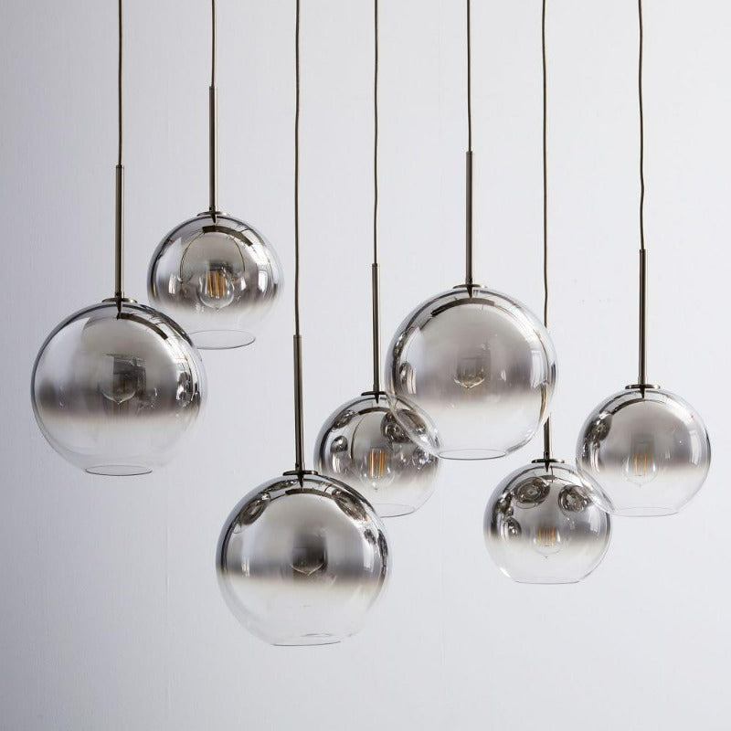 Contemporary glass ball pendant light with brass finish, perfect home decor for living & dining rooms.