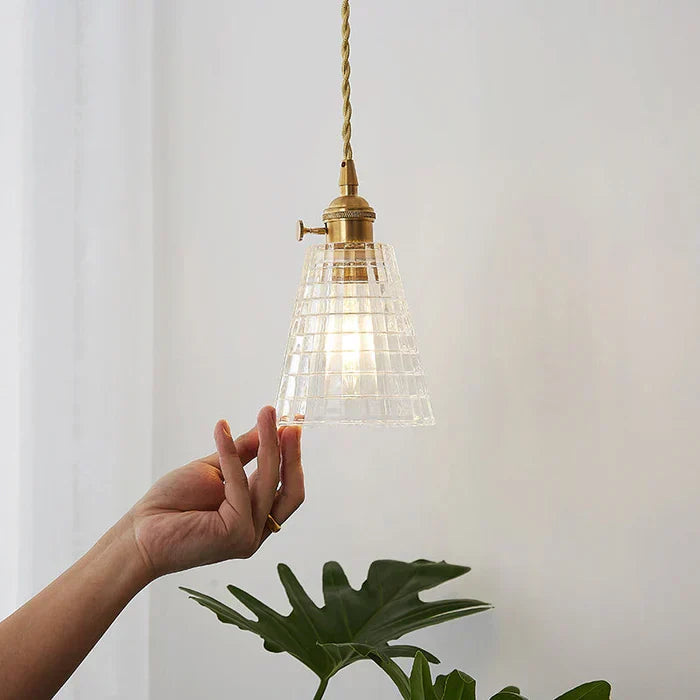 Transparent glass hanging light, adds a touch of industrial elegance to kitchens.