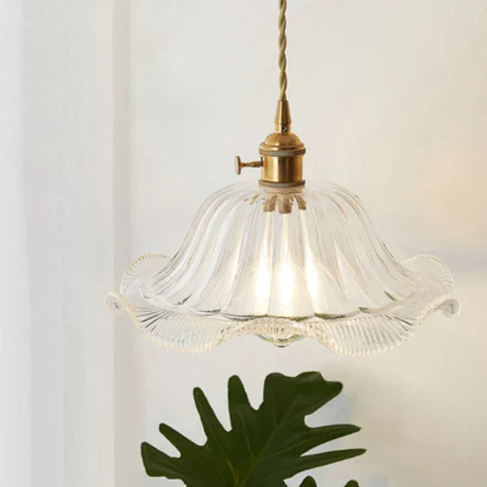 Sleek glass pendant lamp, provides modern lighting for dining areas.