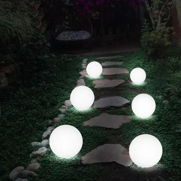 Decorative spherical GlowSphere light accentuating garden features