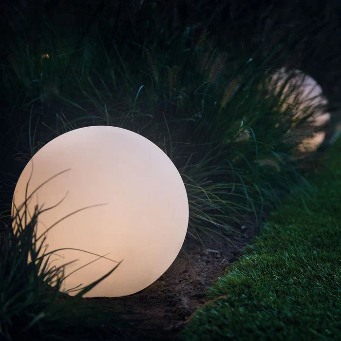 Modern spherical garden light, GlowSphere design, on a patio
