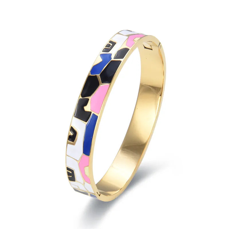 Stylish women's gold cuff bracelet with a beautiful geode and delicate charm, perfect jewellery.