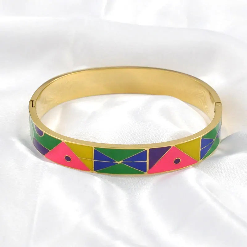 Women's elegant gold cuff bracelet featuring a unique natural geode and a delicate charm.