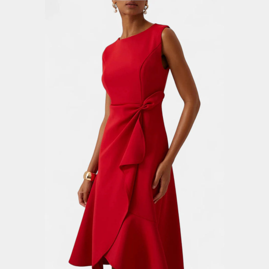 Woman posing in an elegant draped asymmetric midi dress, flattering and perfect for evening parties.