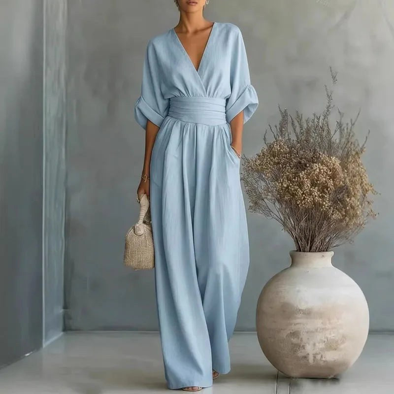 Comfortable women's one-piece wide-leg jumpsuit with V-neck & wrap front, versatile for casual or elegant wear.