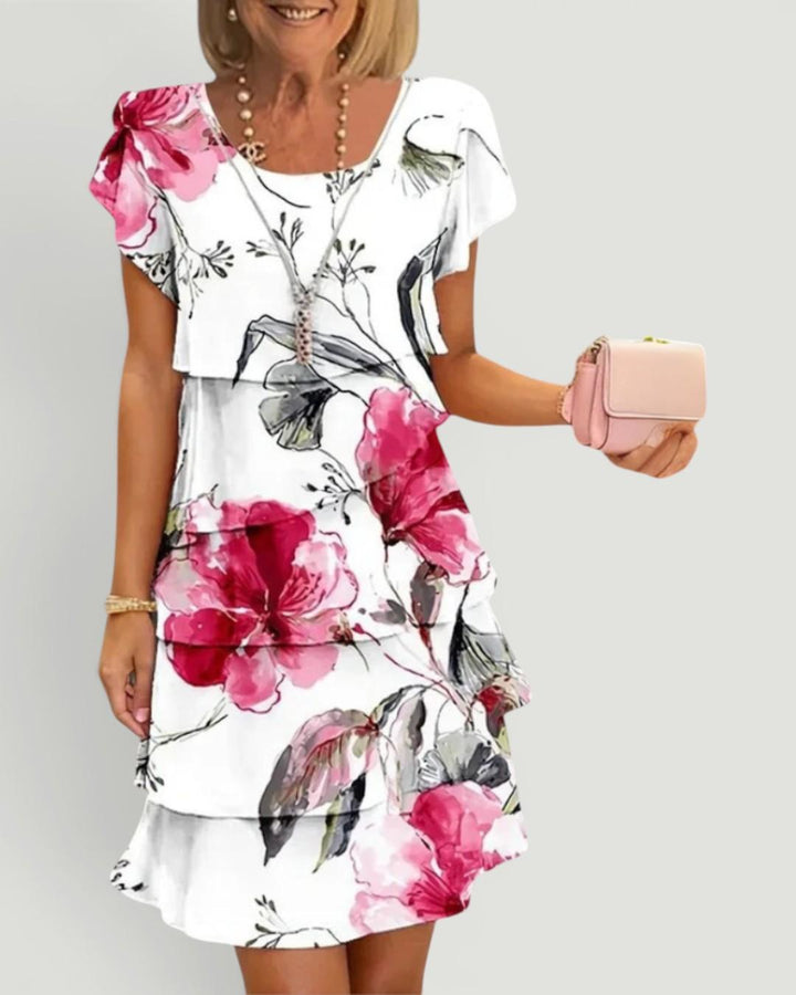 Elegant women's tiered floral midi dress with flowy fabric, perfect for summer day wear.