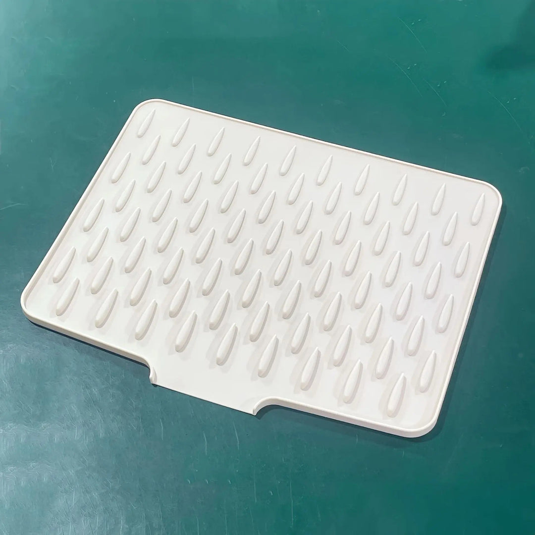 Grey non-slip silicone draining mat for fast dish drying & kitchen counter protection. BPA-free & heat resistant.
