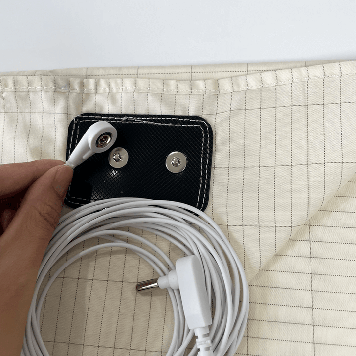 Conductive silver thread grounding bed sheet promoting deeper sleep & pain relief.
