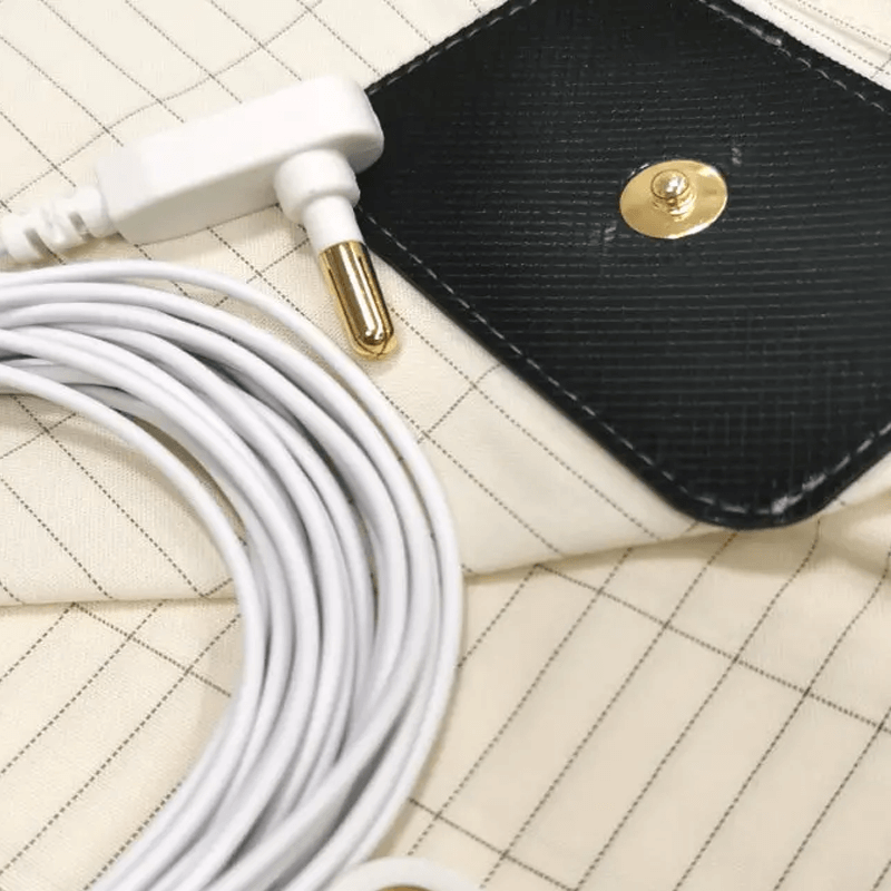 Soft grounding bed sheet with silver for conductive connection to earth, enhancing sleep.