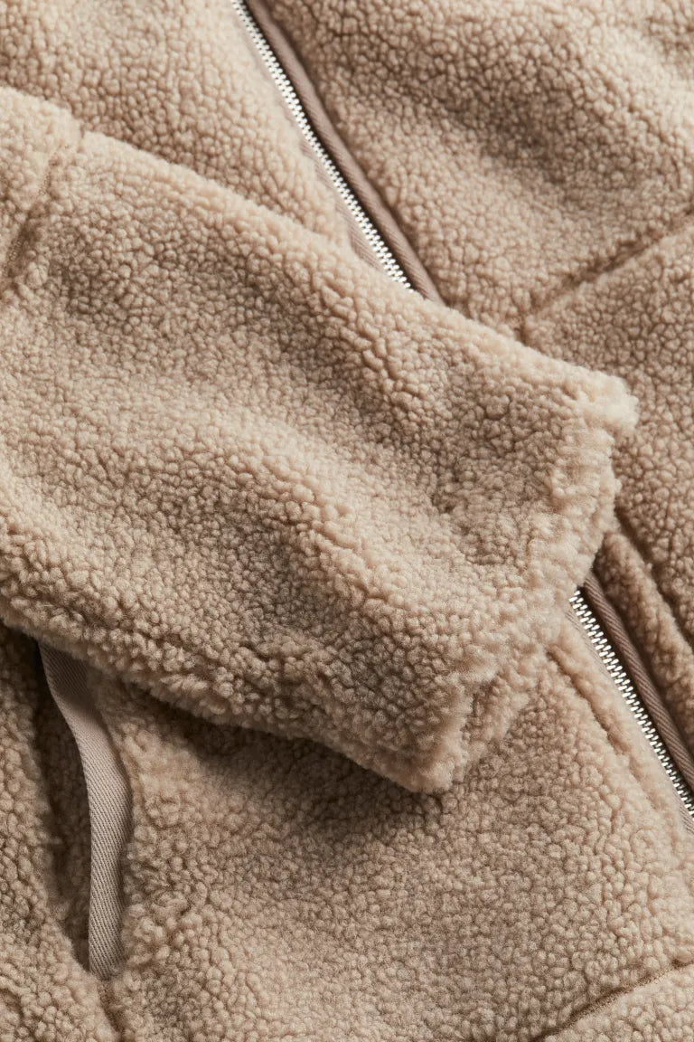 Soft, plush women's teddy jacket. Provides cozy warmth and stylish comfort, perfect winter outerwear for layering.