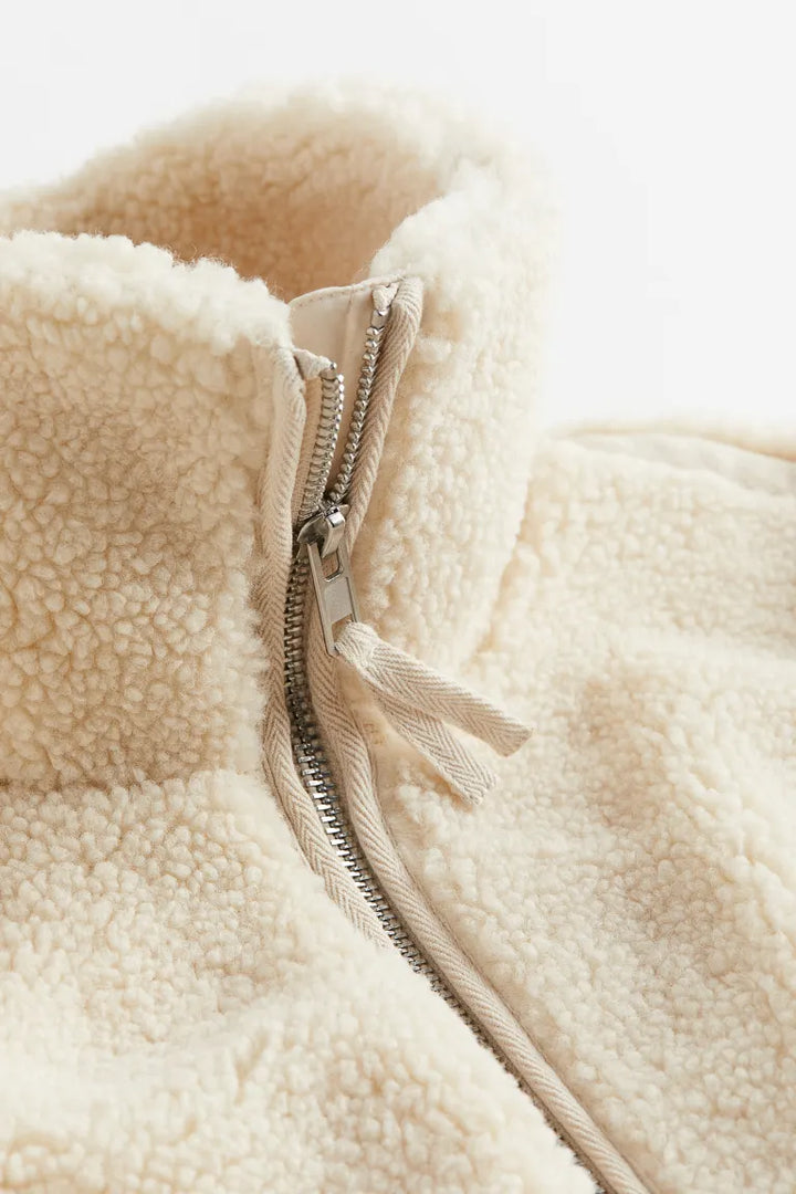 Women's zippered teddy jacket for cold weather. Cozy and warm outerwear, ideal for winter style and comfort.