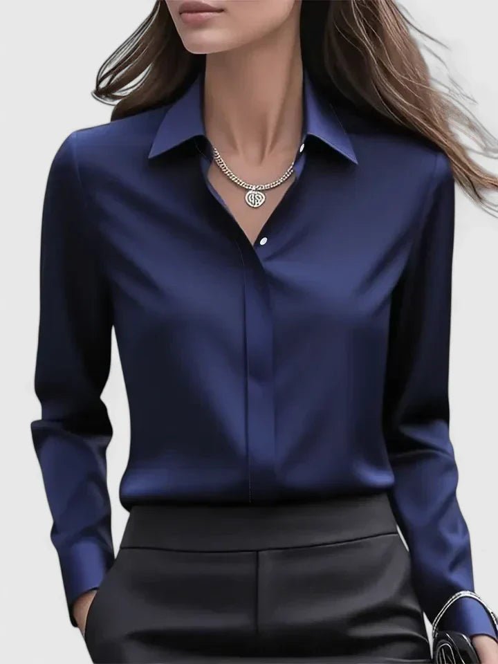 Women's navy blue long-sleeve blouse with stylish concealed placket. Elegant professional workwear.