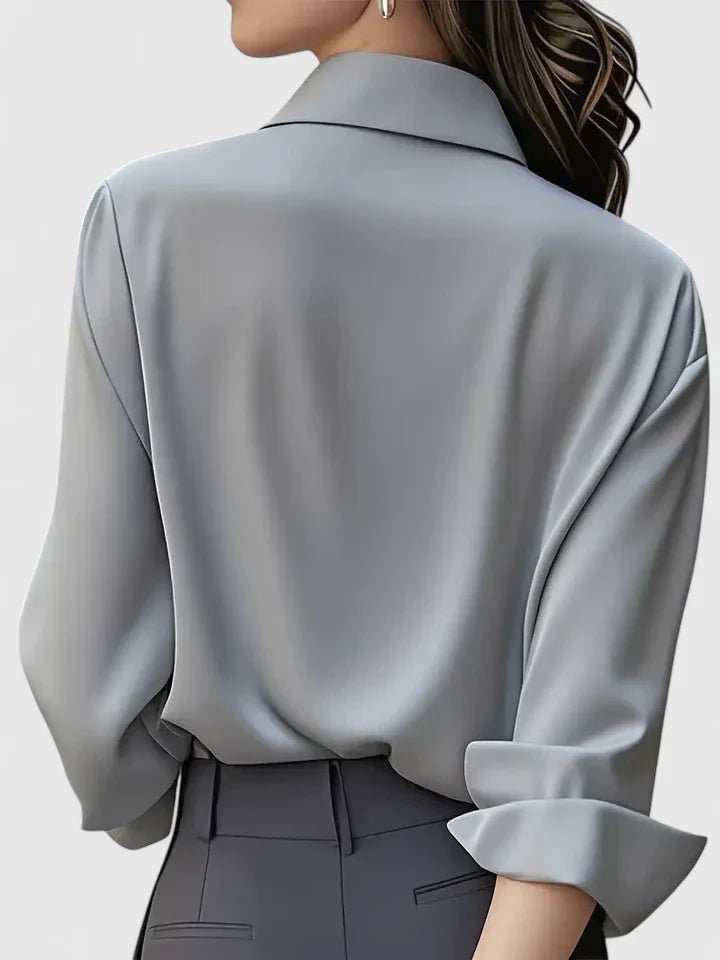 Tailored women's long-sleeve blouse, elegant and sleek with a concealed placket for professional wear.