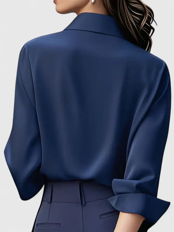 Classic women's long-sleeve button-down blouse, styled with a concealed placket. Essential office fashion.