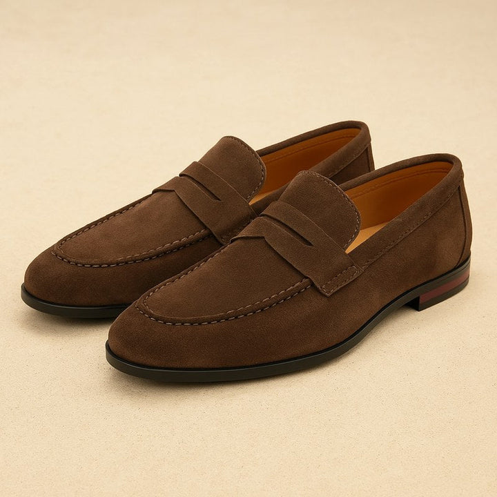 Elegant men's black dress loafers paired with a suit, ideal for formal events and sophisticated occasions.