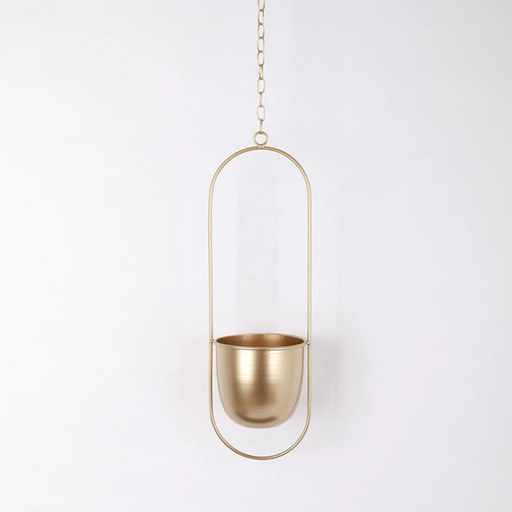Sleek metal hanging planter, ideal for indoor plants & modern home decor accents. Perfect for living spaces.
