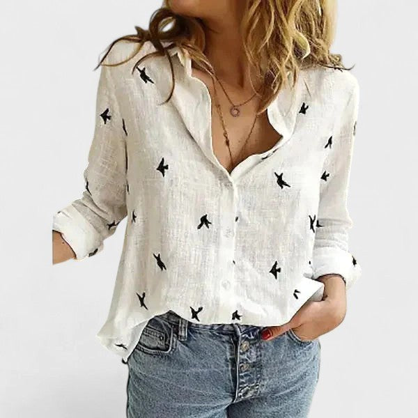 Woman wearing a long sleeve smart-casual button-down shirt with lapel collar, styled for work.