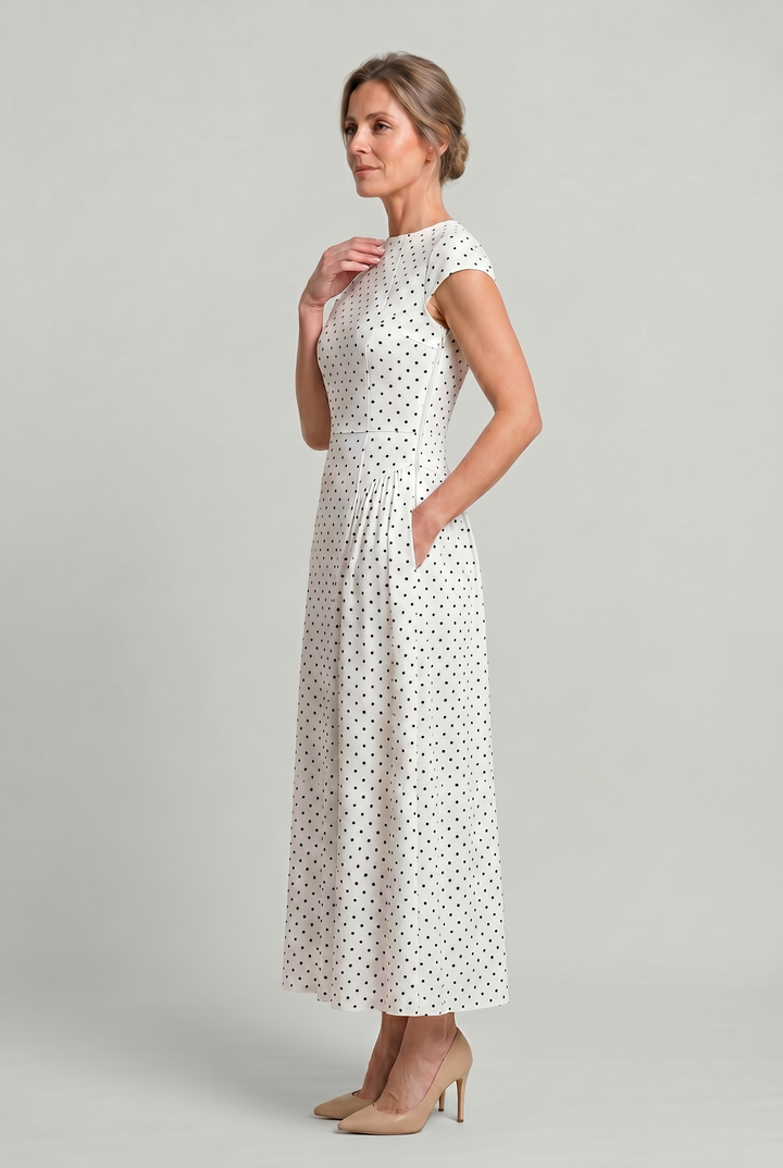 Chic women's polka dot A-line maxi dress with cap sleeves, round neck. Classic summer dress for elegant style.