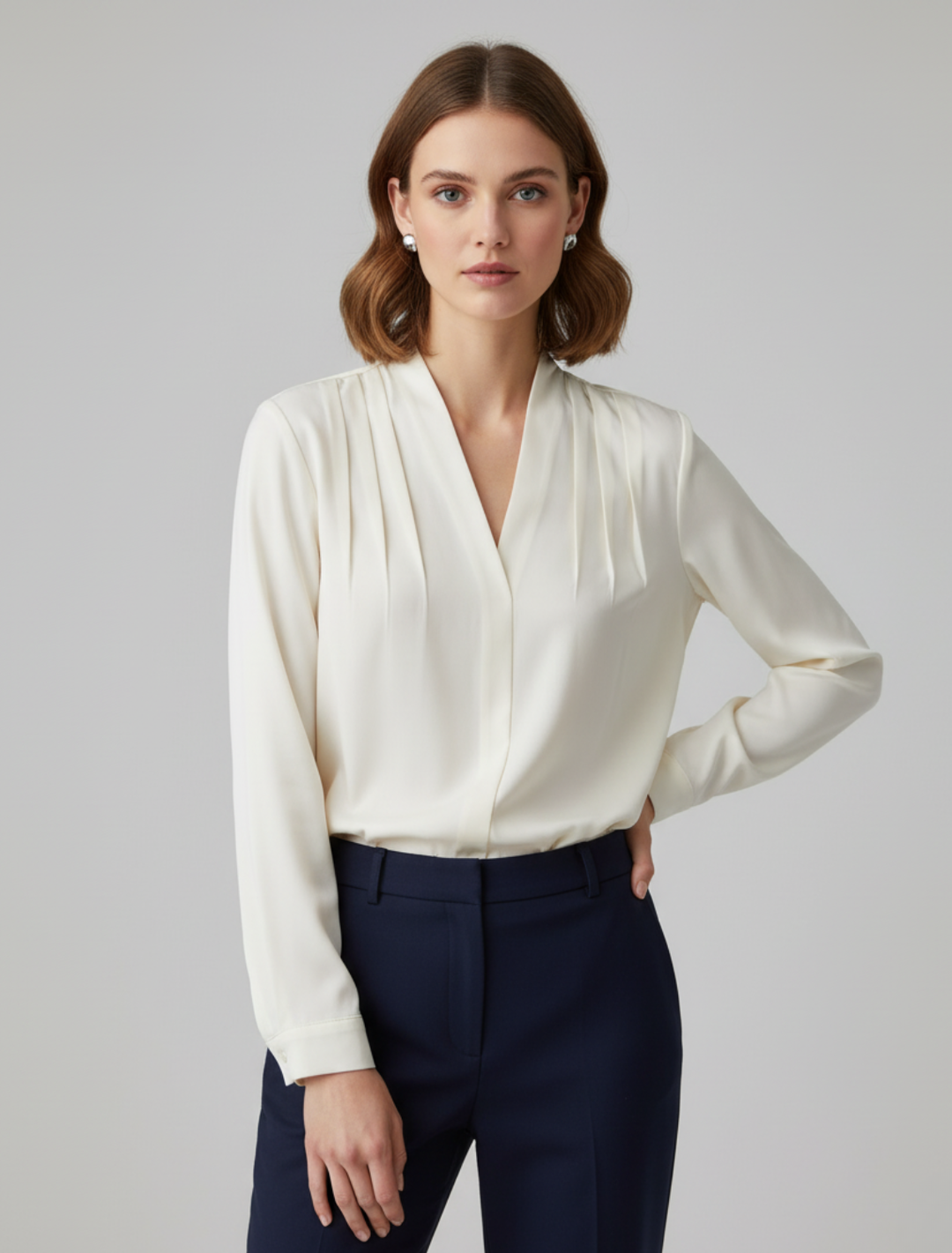 Elegant women's pleated V-neck blouse, ideal for office or smart casual. Long sleeve, sophisticated top.