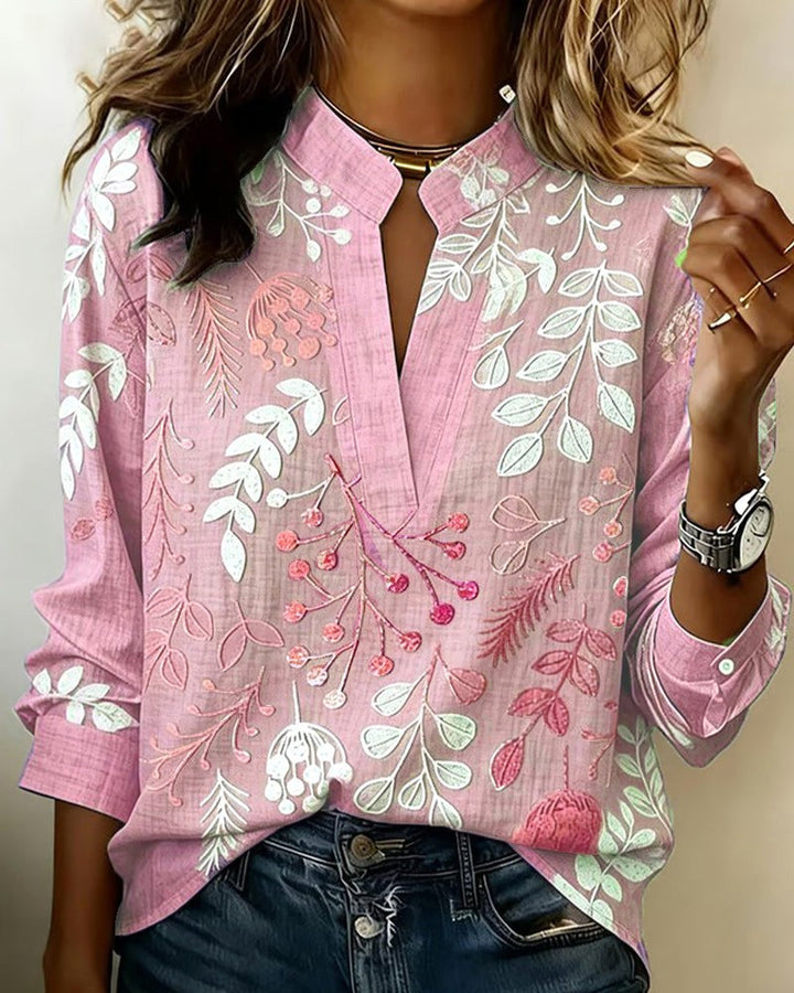 Spring/summer women's V-neck floral blouse, airy fabric and vibrant flower print for a fresh look.