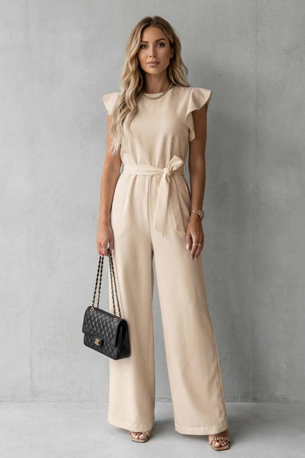 Formal wide-leg jumpsuit for women, featuring chic ruffle sleeves & a sleek belted design. Perfect for special events.