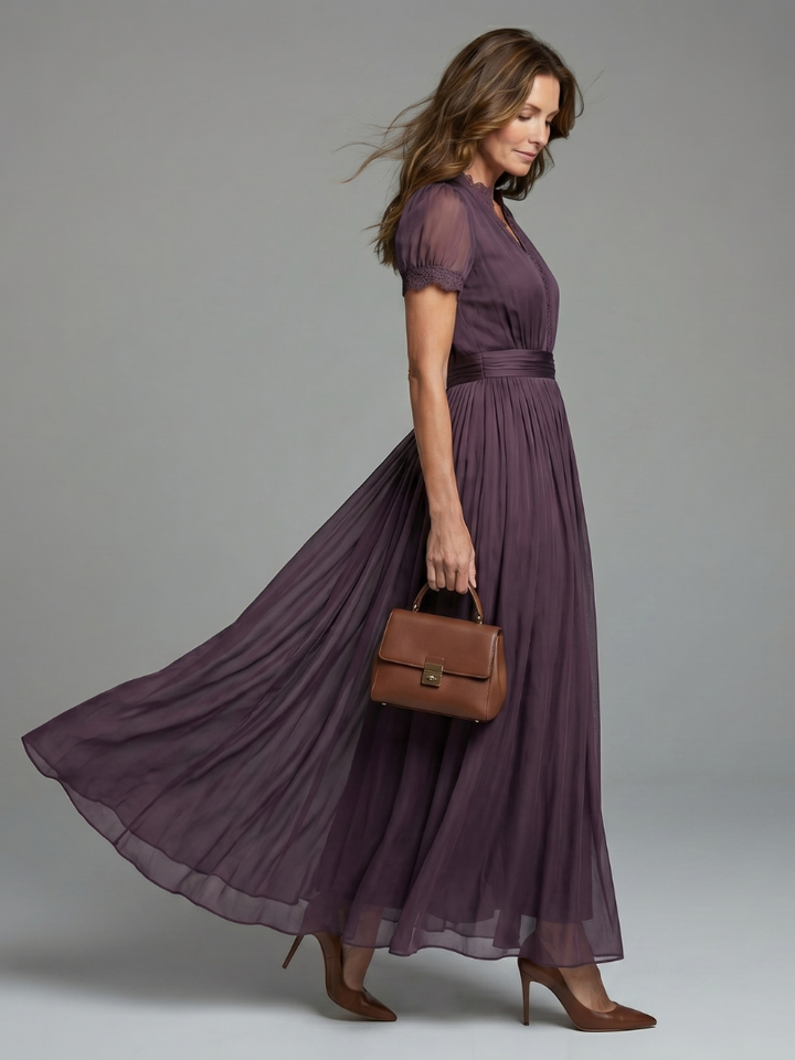 Sophisticated women's evening gown in dark purple with sheer sleeves & pleated waist, ideal for formal events.