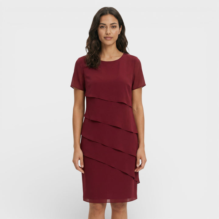 Elegant women's tiered ruffle midi dress. Sophisticated cocktail party and special occasion evening wear.