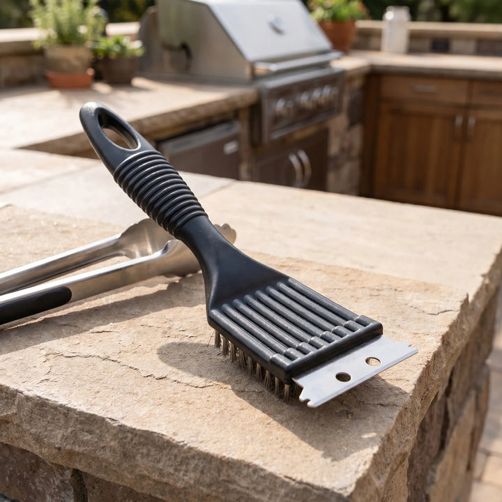 Close-up of black heavy-duty grill cleaner brush with robust bristles & integrated scraper for tough BBQ grease.