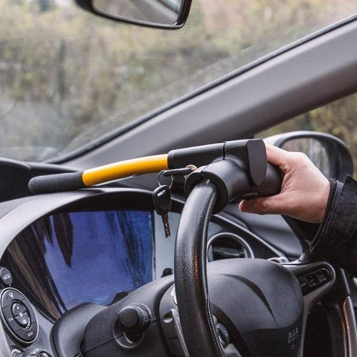 Bright yellow heavy-duty steering wheel lock, a universal anti-theft device for enhanced car security.