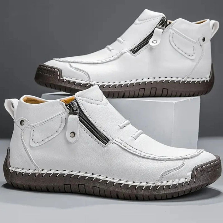 Relaxed men's orthopedic ankle boots with a side zip & stitching, providing supportive footwear for daily wear.