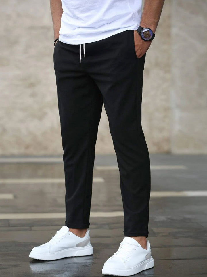 Stylish men's slim-fit jogger pants, showing ankle-length modern fit and comfortable versatile design.
