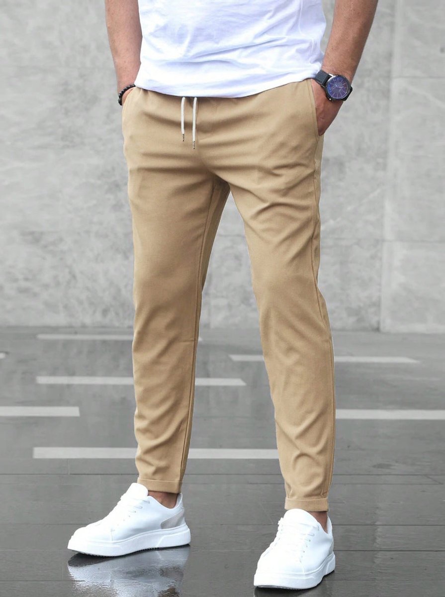 Detail shot of men's jogger chinos, highlighting the adjustable drawstring, slim-fit cut, and casual appeal.