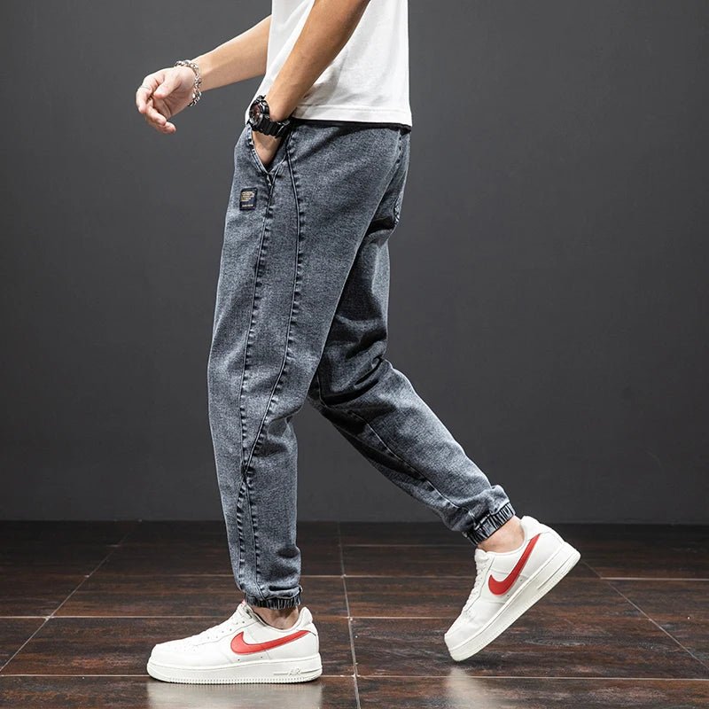 Men's casual blue denim joggers with ultimate stretch comfort, an elastic waist, and a stylish tapered leg.