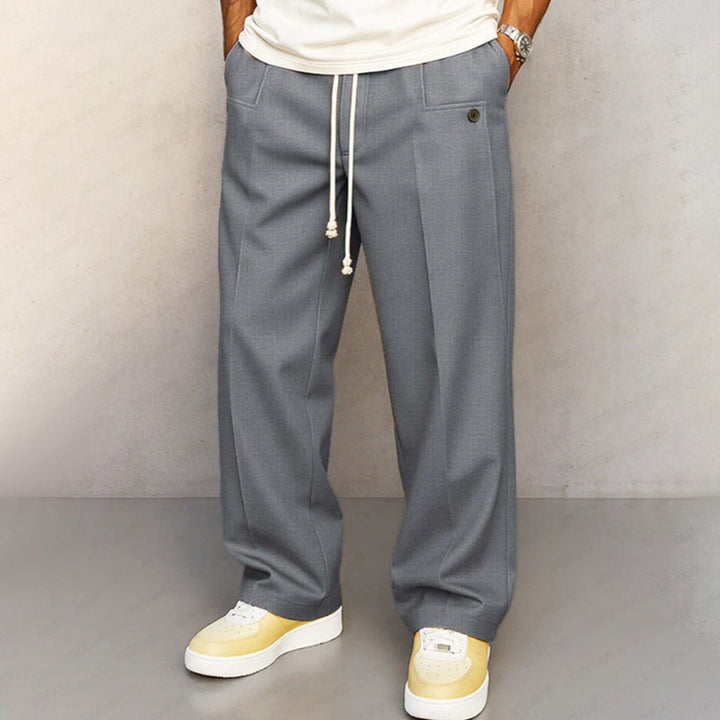 Front view of men's casual khaki wide leg pants with a visible drawstring waist, offering relaxed comfort.