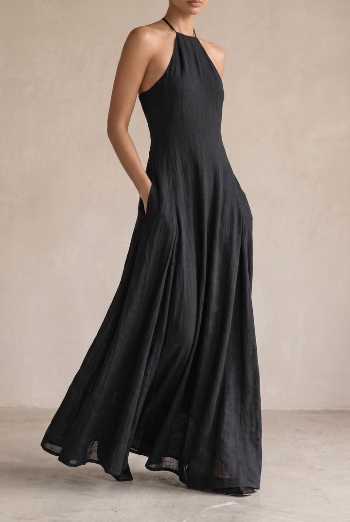 Breathable black halter maxi dress for women, ideal for summer. Features a relaxed, flowy fit & sleeveless design.