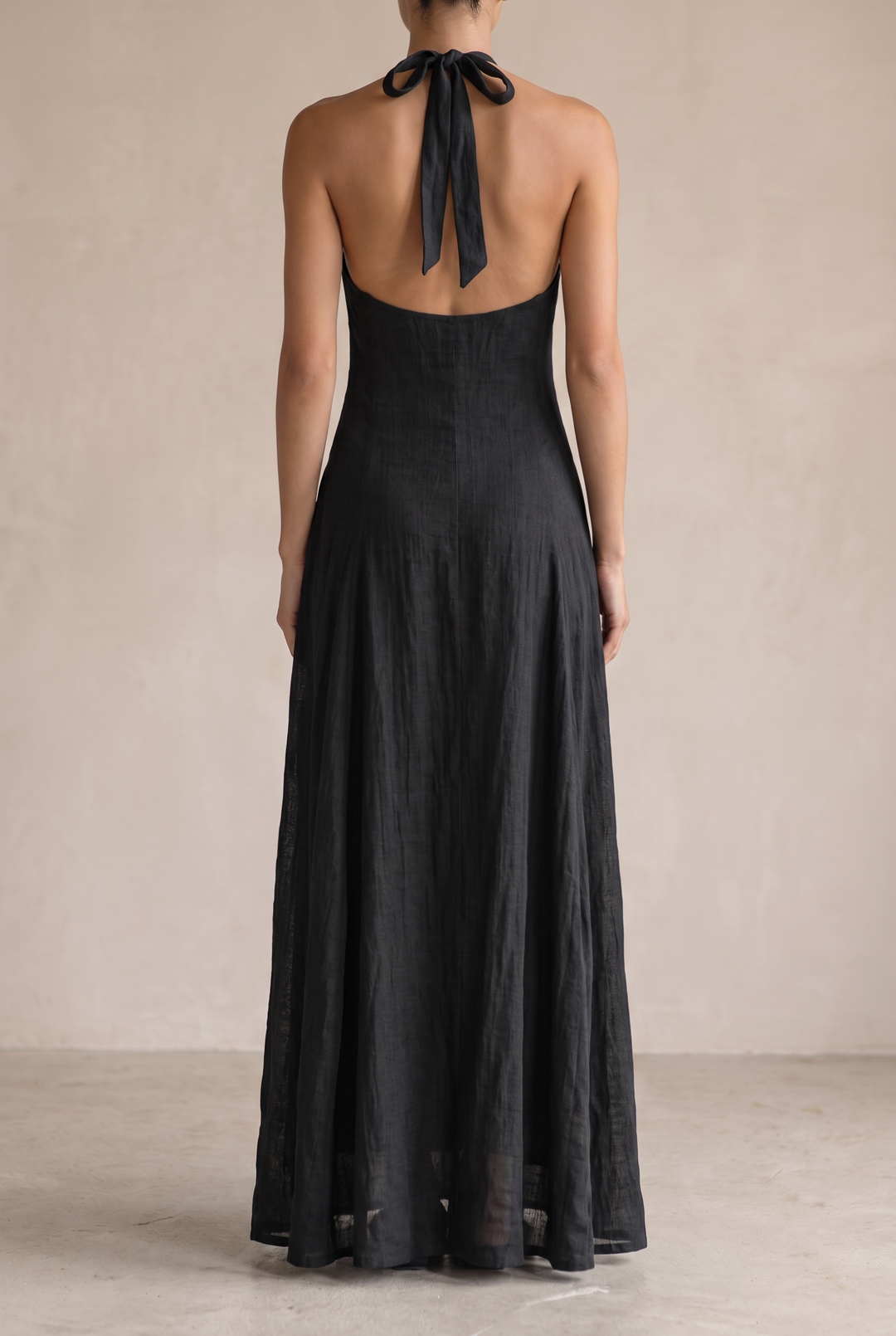 Stylish black halter neck maxi dress for women, suitable for both casual daytime & elegant evening wear. Sleeveless comfort.