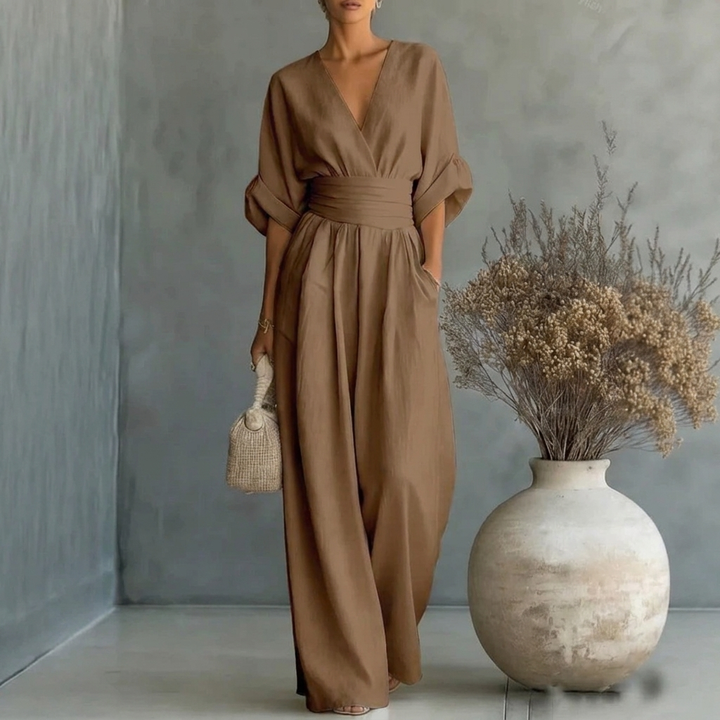 Model wears a comfortable women's short sleeve V-neck wide leg jumpsuit, perfect for casual spring fashion.