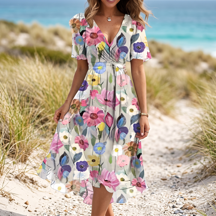 Breezy women's floral summer midi dress, V-neck and flutter sleeves, ideal for warm weather events.